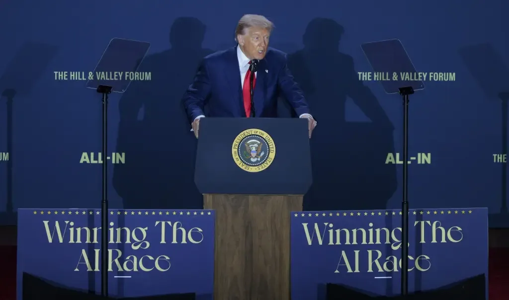 President Trump speaks at a podium bearing the presidential seal, with 'Winning The AI Race' signage and Hill & Valley Forum branding behind him
